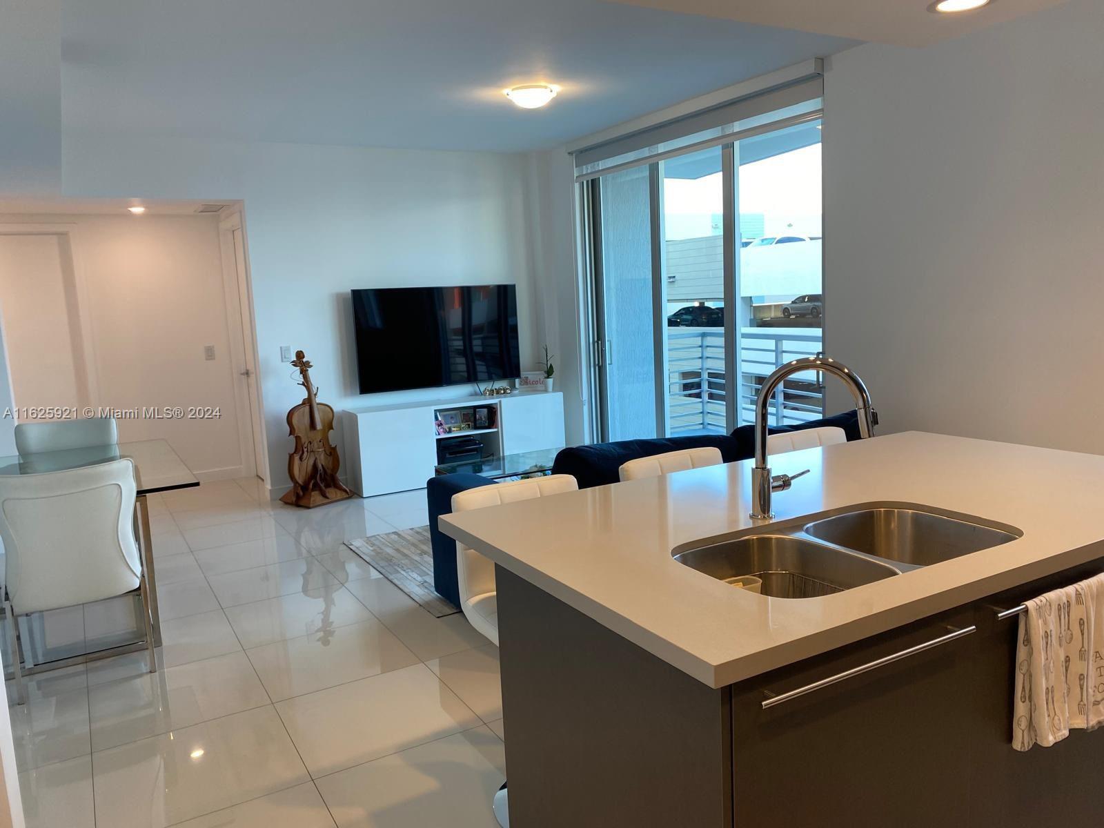 a kitchen with a sink and a refrigerator