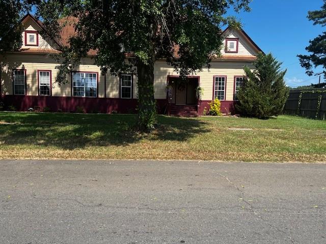 a view of house with outdoor space and parking