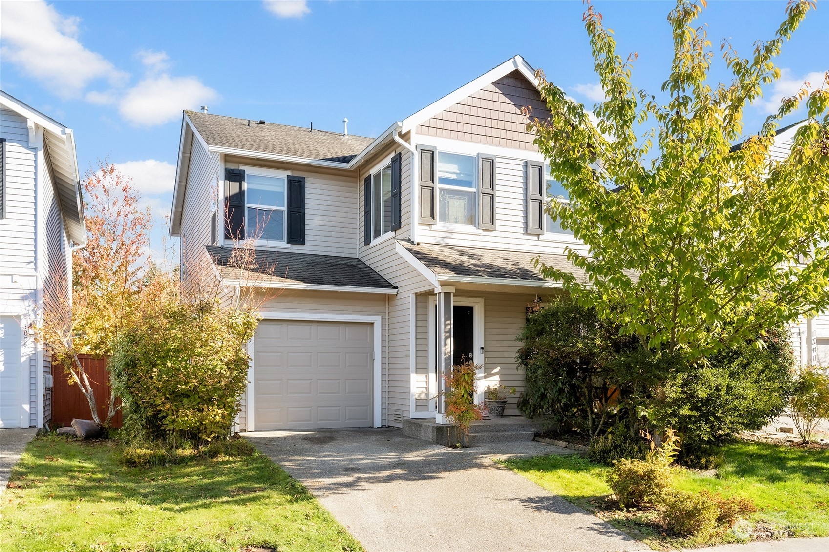 a front view of a house with a yard garage and outdoor seating