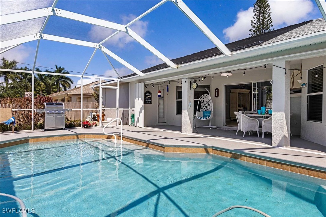 a view of a house with swimming pool and sitting area