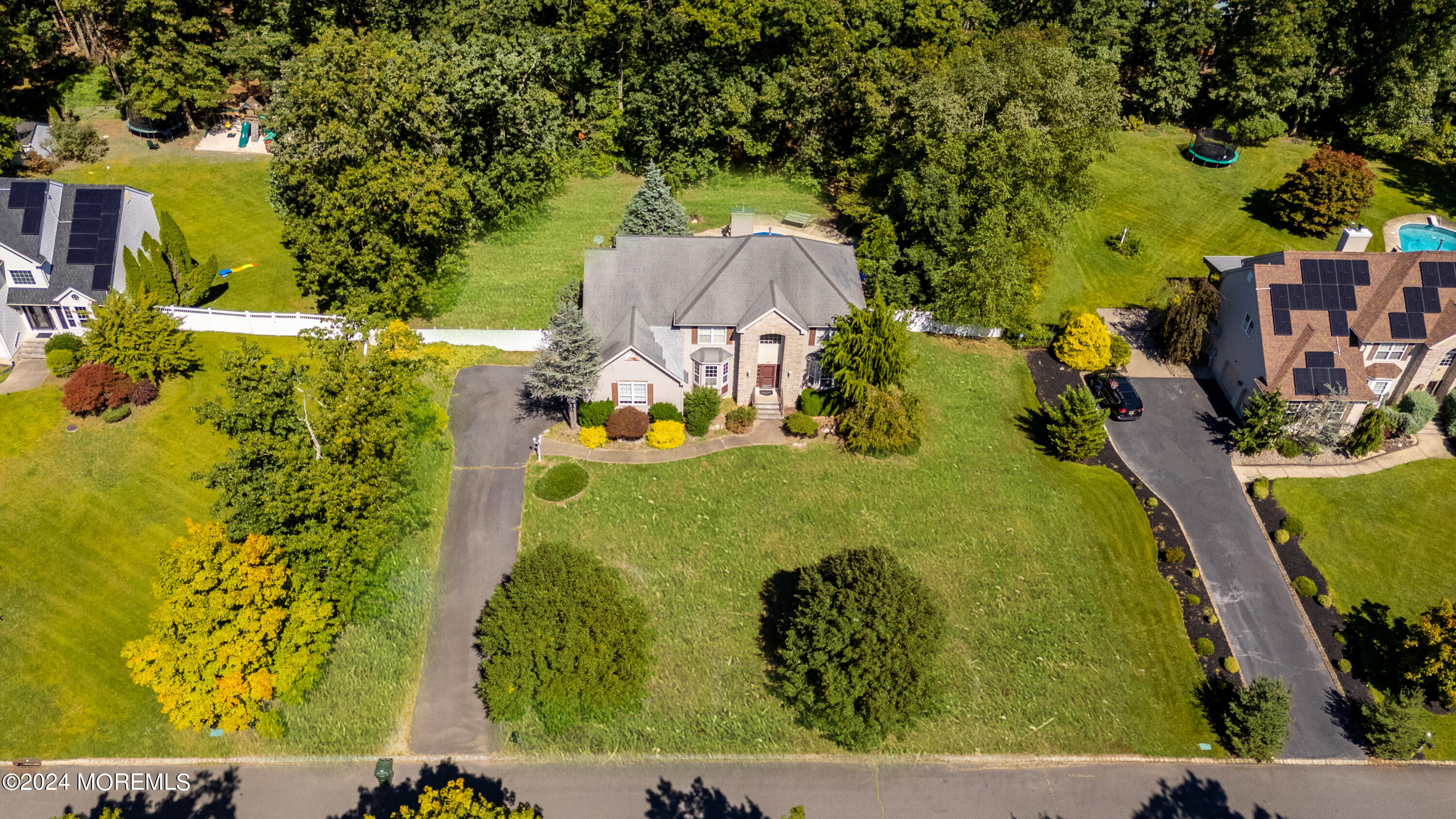 an aerial view of a residential apartment building with a yard