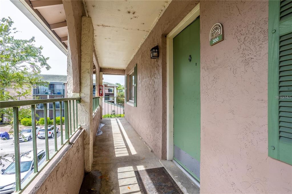 a view of a balcony with wooden floor