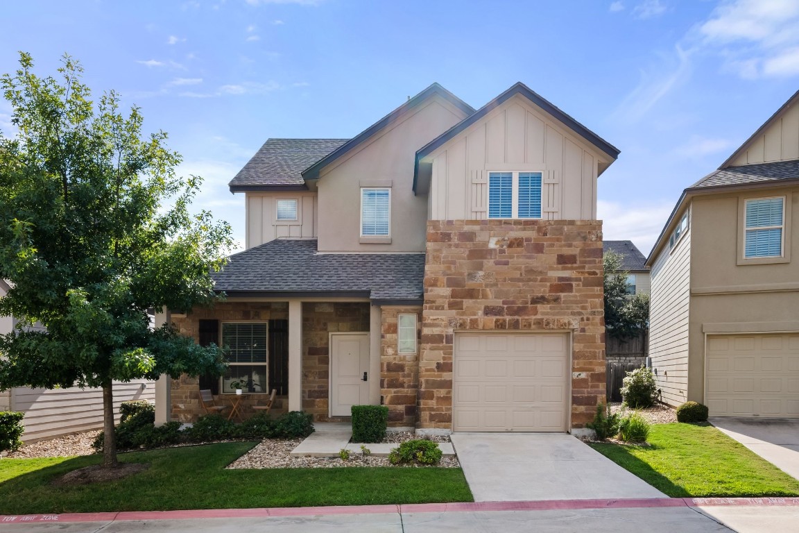 a front view of a house with a yard and garage