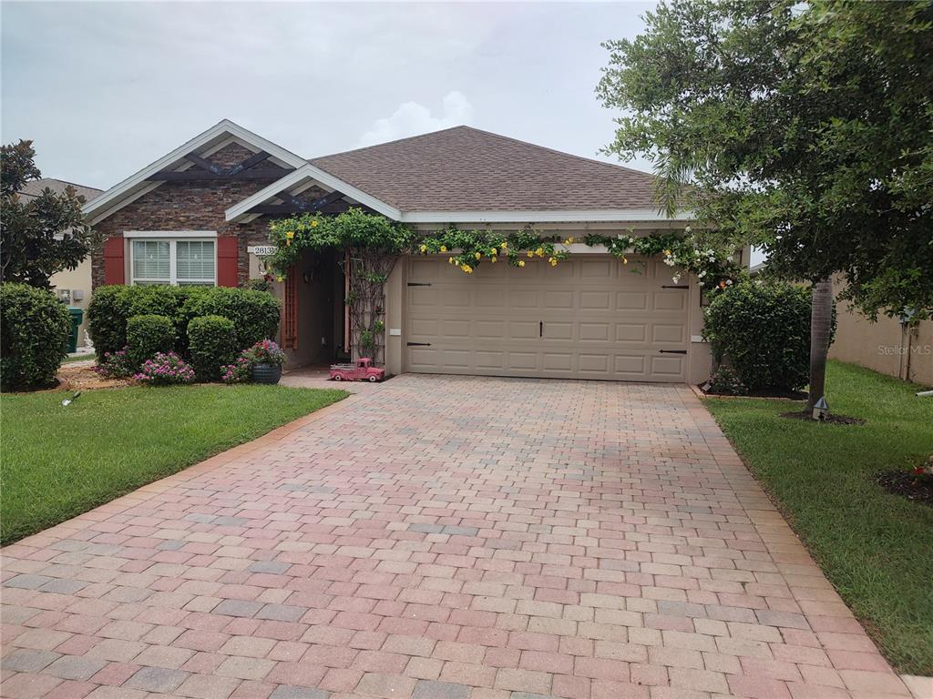 a front view of a house with a yard and garage