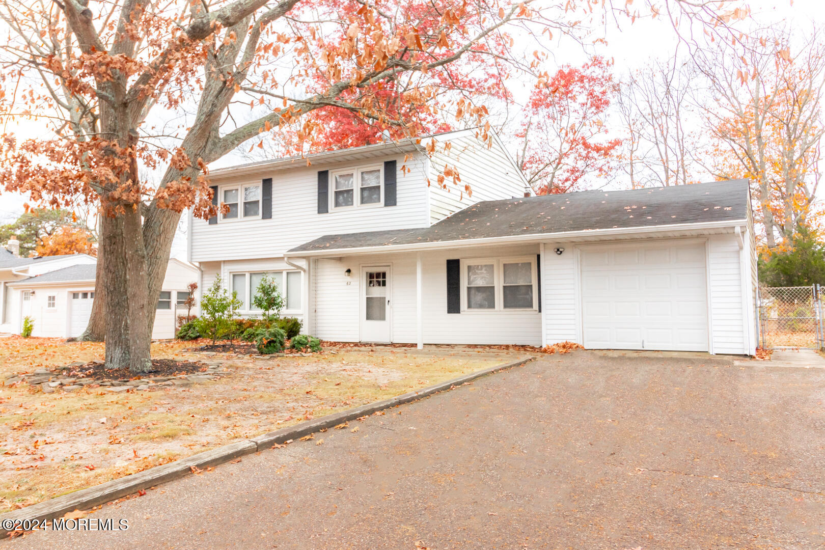 a front view of a house with a garden and yard