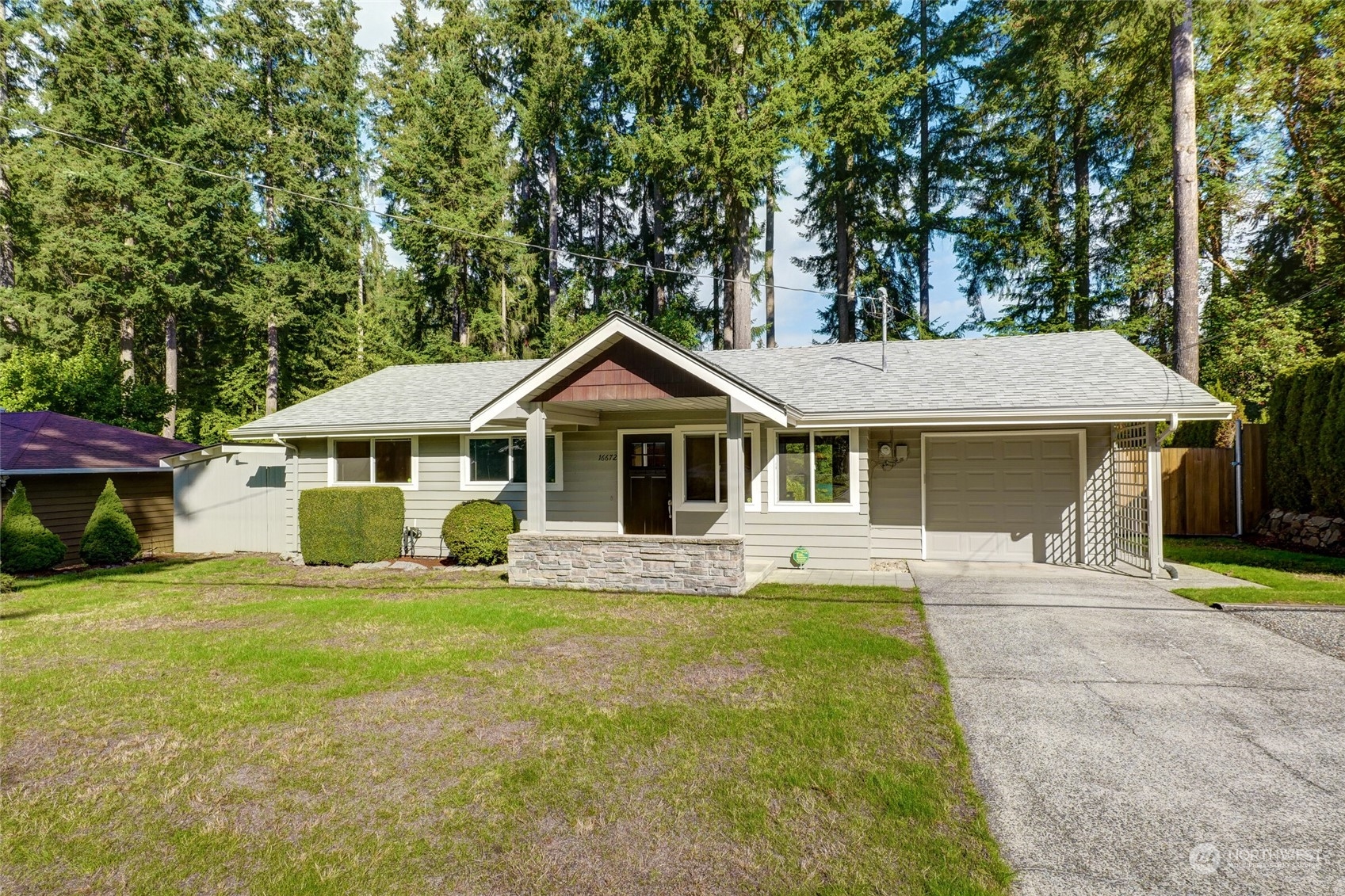 a front view of a house with a yard and trees