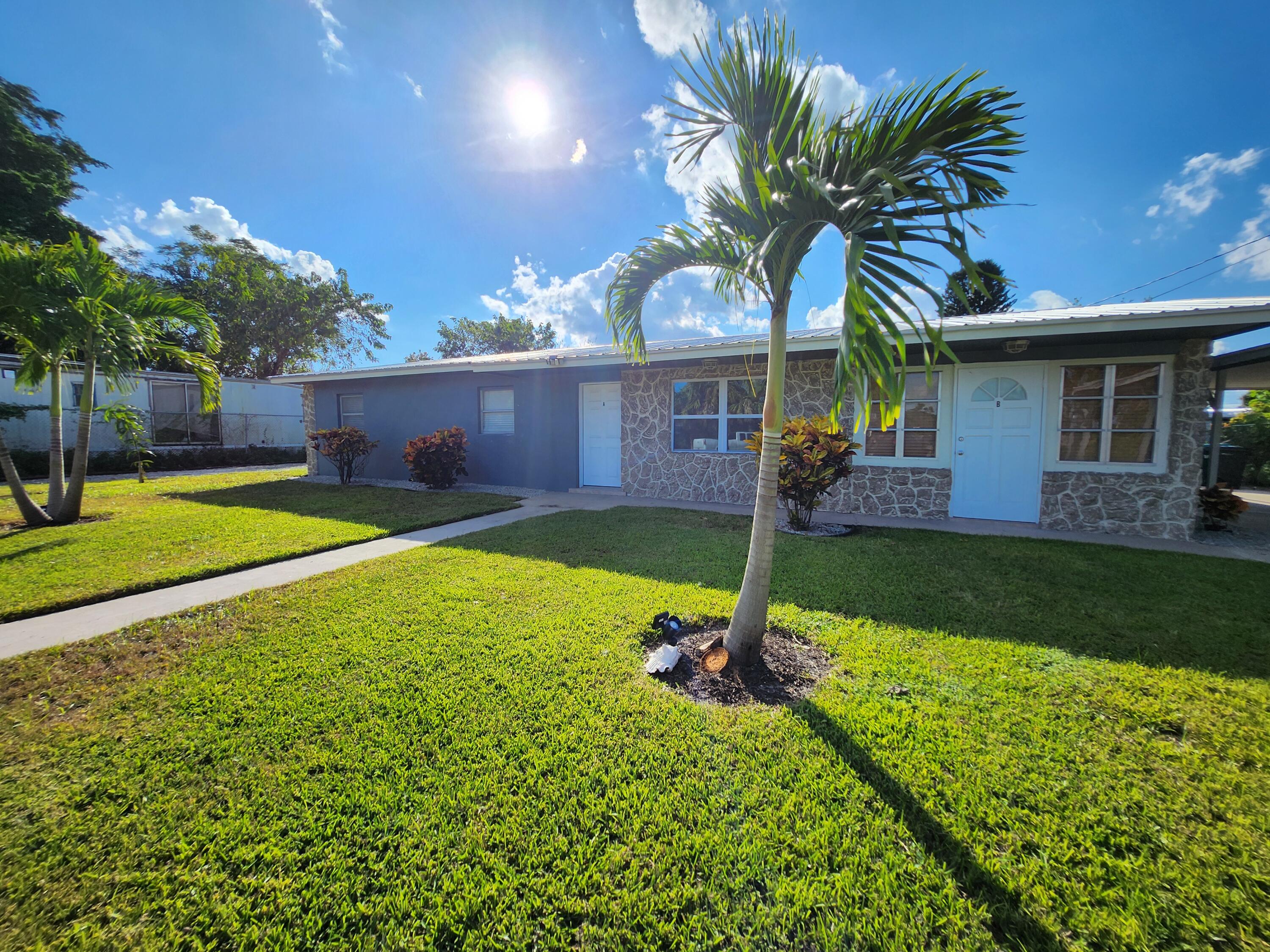 a front view of house with yard and outdoor seating