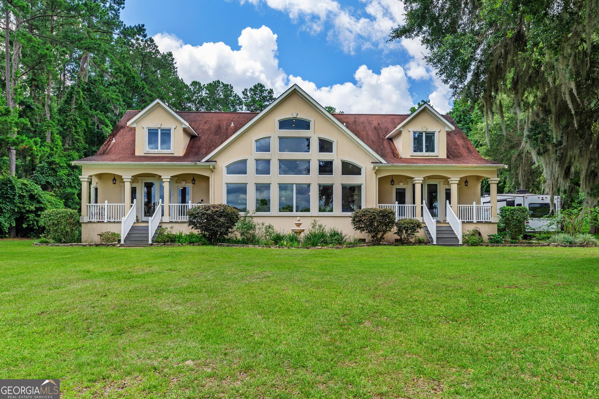 a front view of a house with a garden