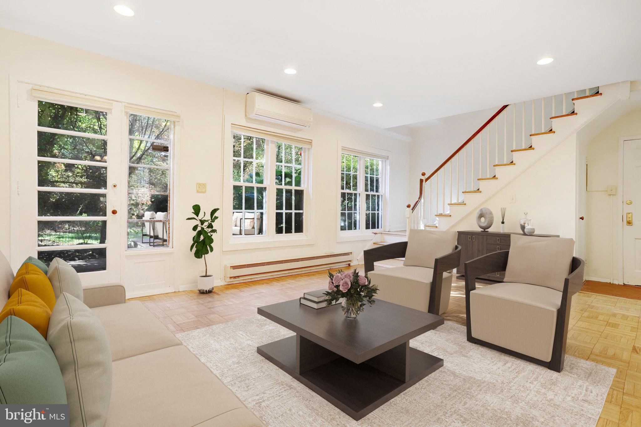 a living room with furniture and floor to ceiling windows