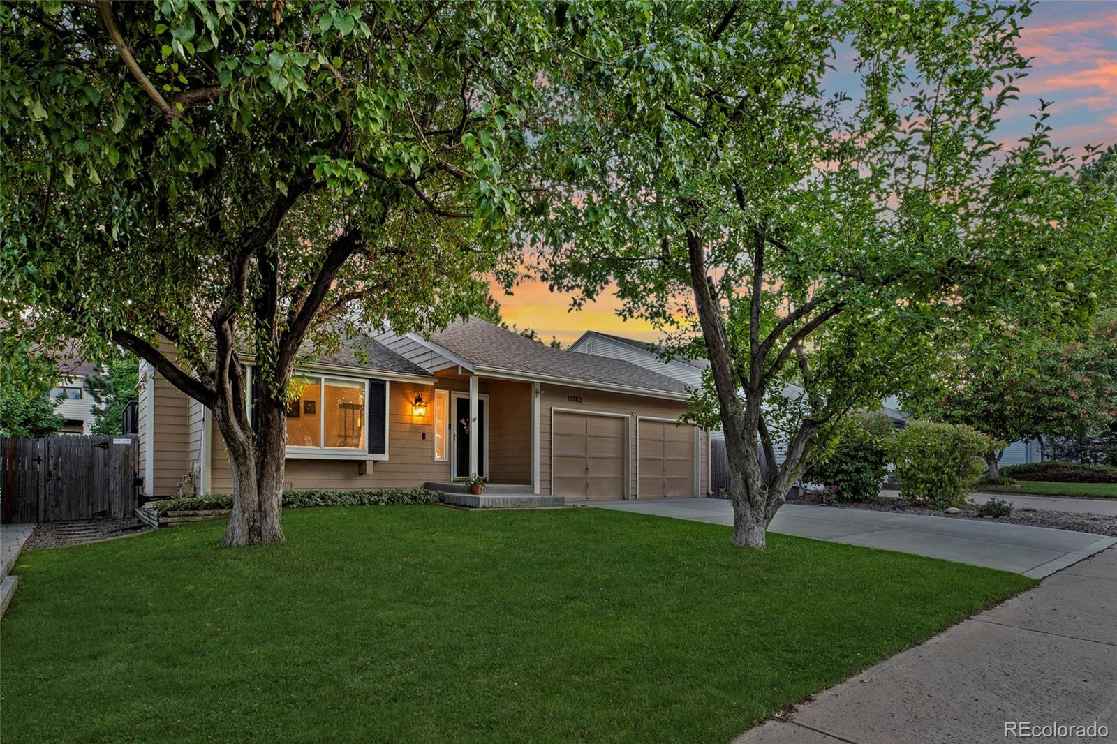 a front view of house with yard and green space