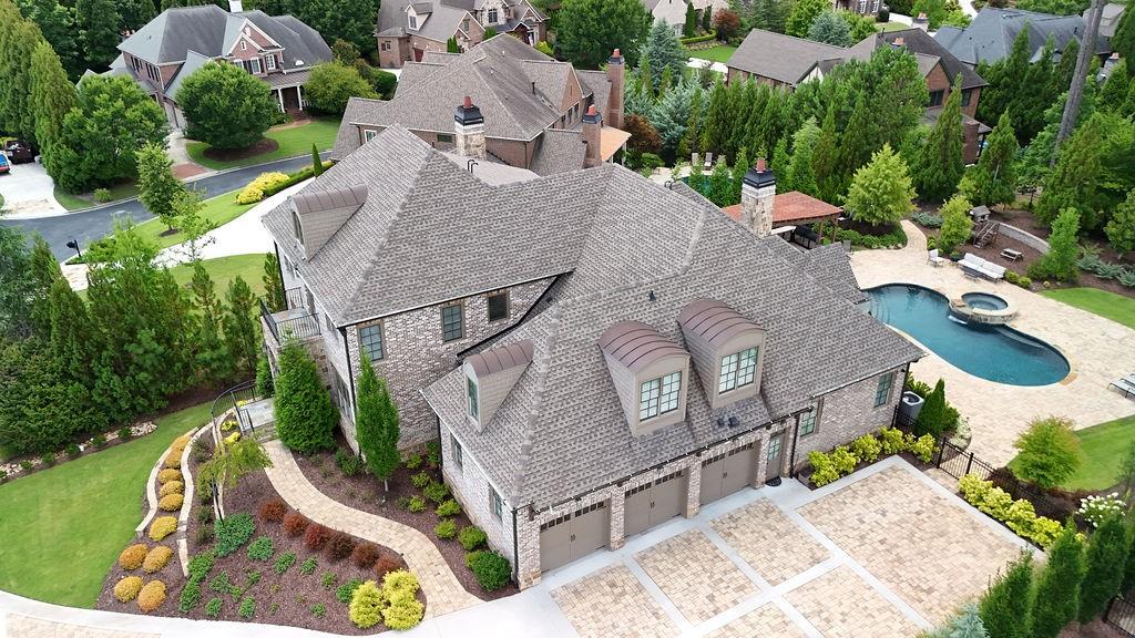 an aerial view of a house with garden space and street view