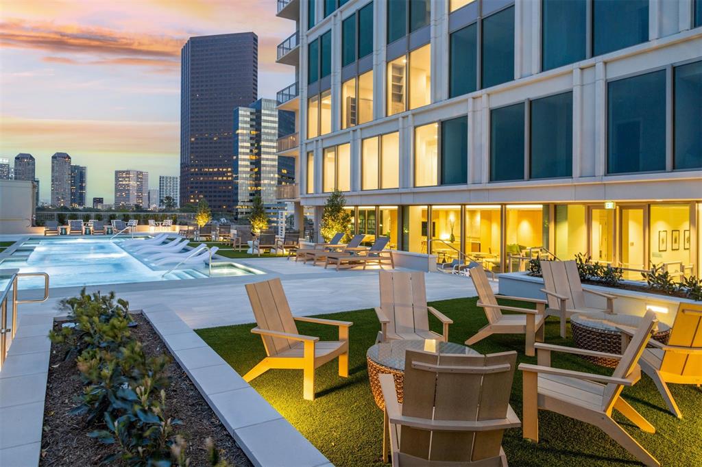 a view of a swimming pool with outdoor seating and a floor to ceiling window