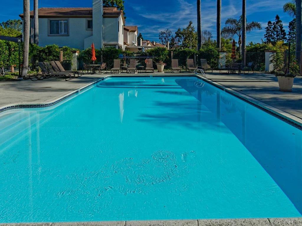 a swimming pool with outdoor seating and yard