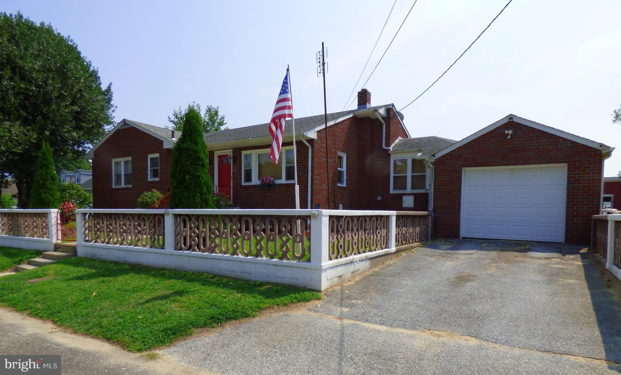 a view of house with a yard and deck