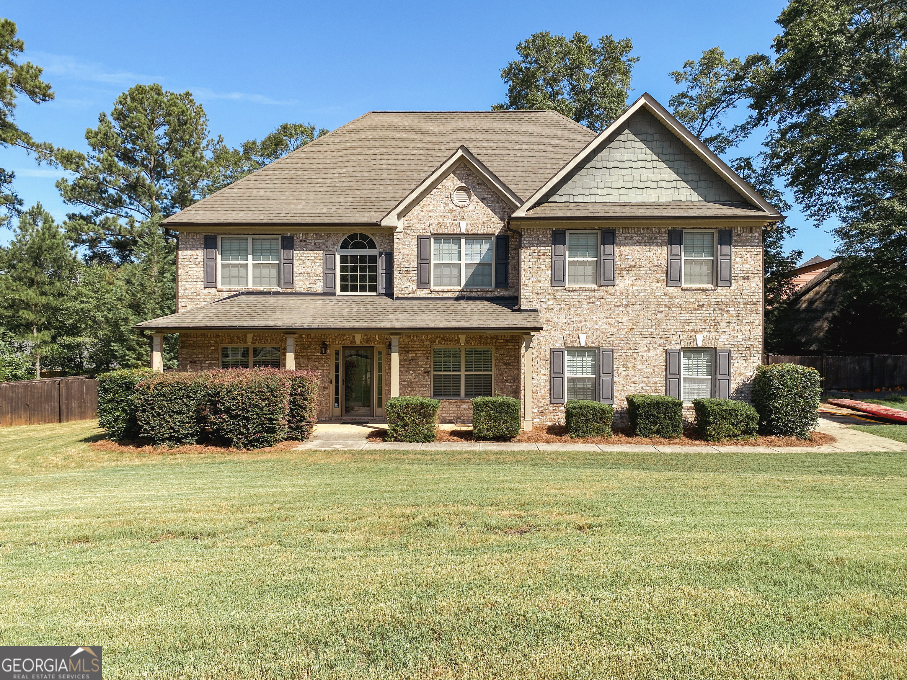 a front view of a house with a yard