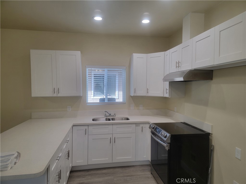 a kitchen with cabinets appliances a sink and a counter top space