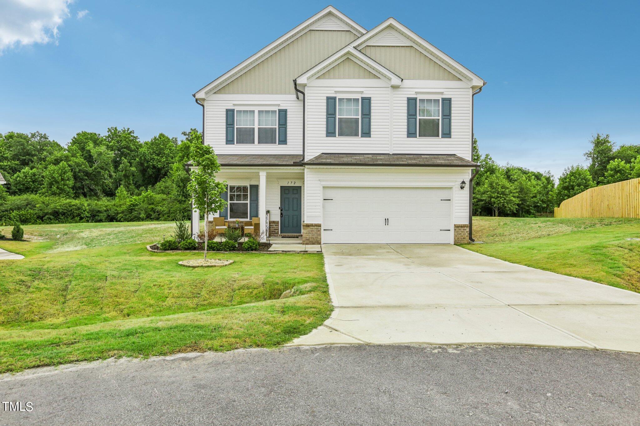 a view of a yard in front view of a house