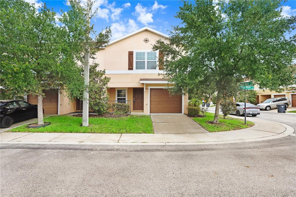 a front view of a house with a yard and garage