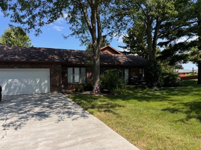 a front view of a house with a garden