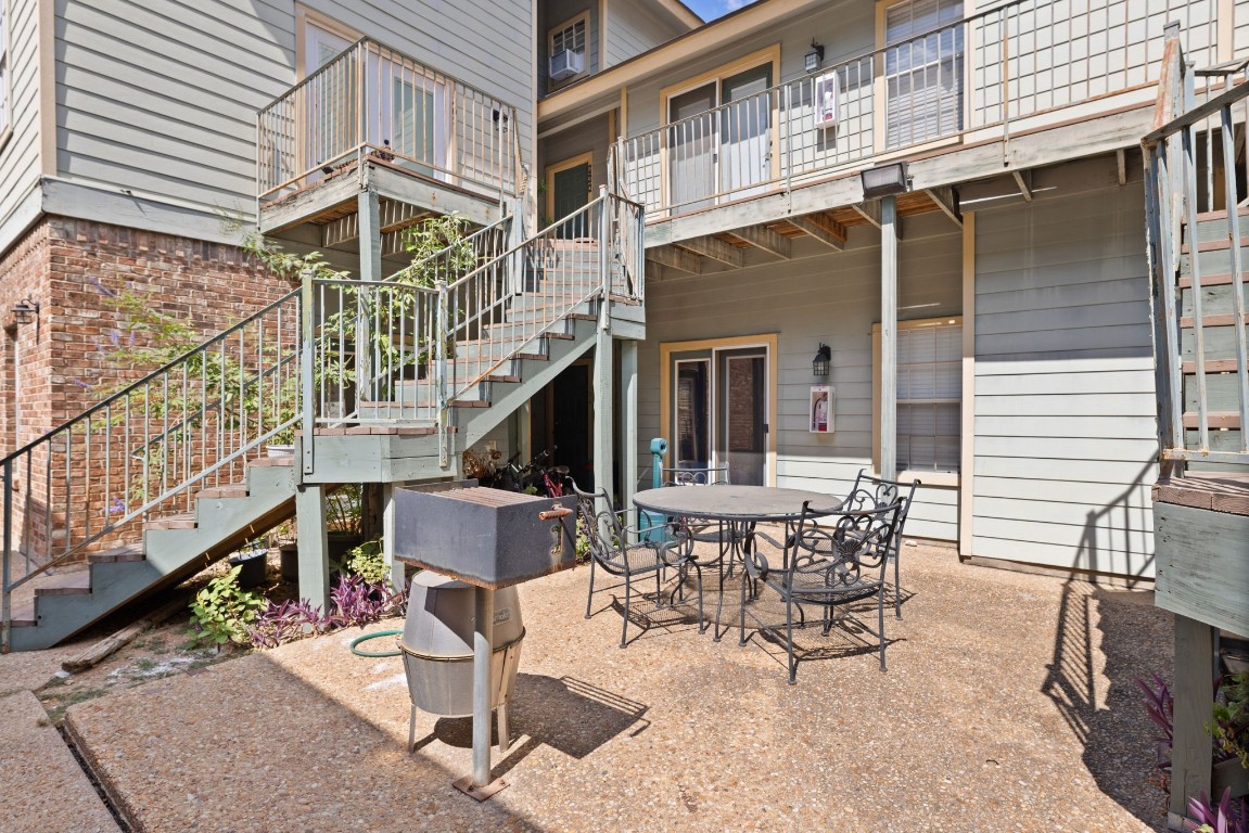 a view of a patio with a table and chairs