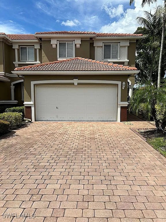 a front view of a house with a yard and garage