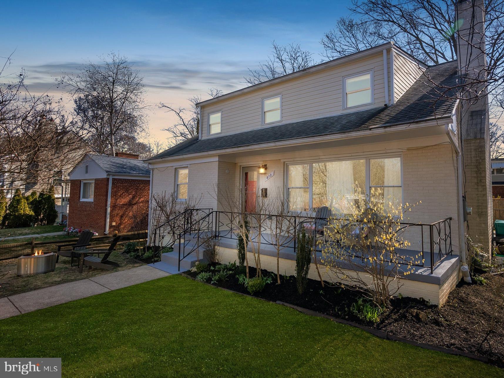 a view of a house with backyard sitting area and garden