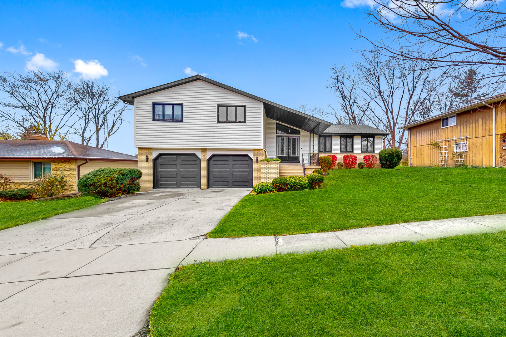 a front view of a house with a yard and garage