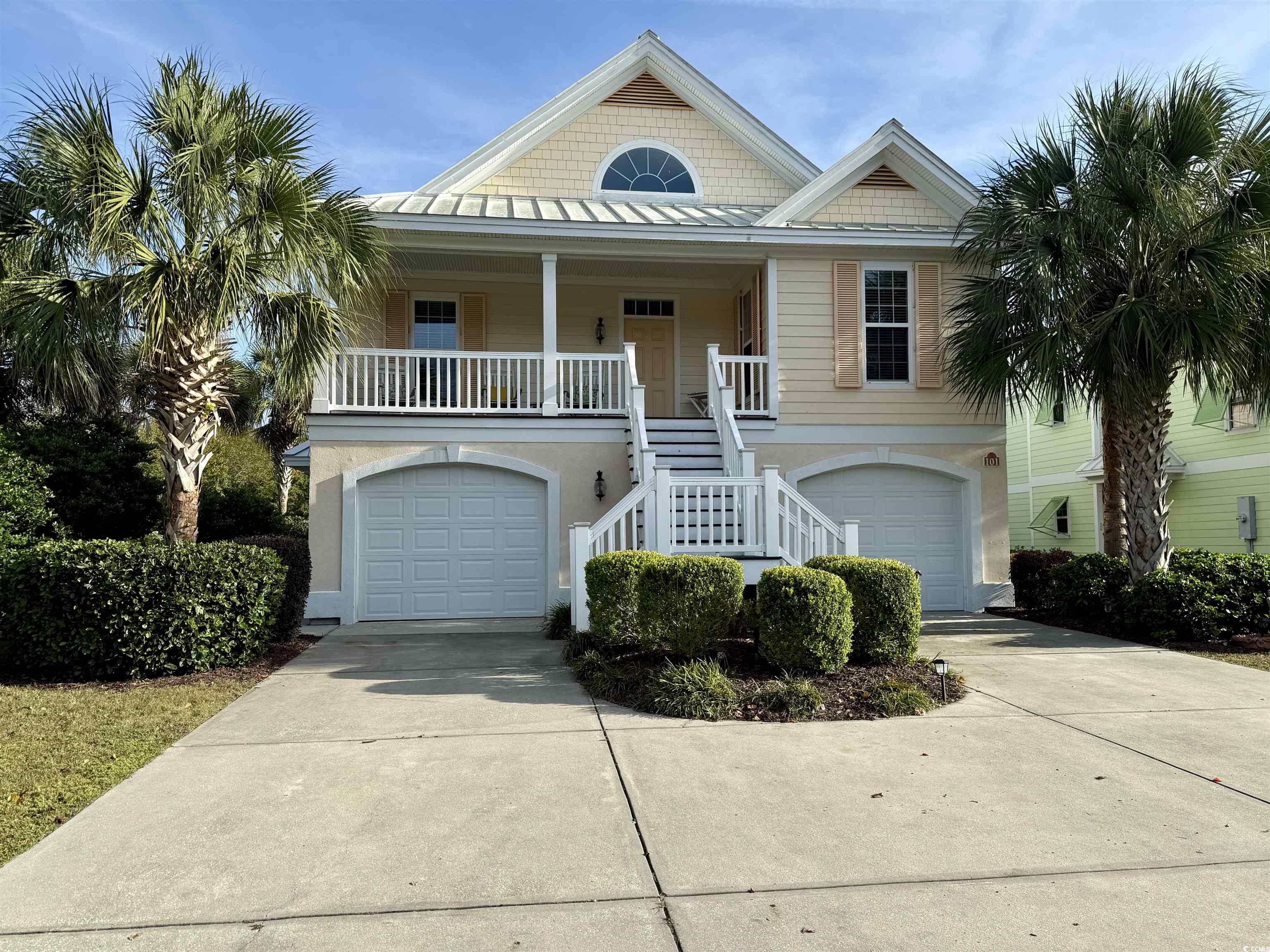 Coastal home with covered porch and a garage