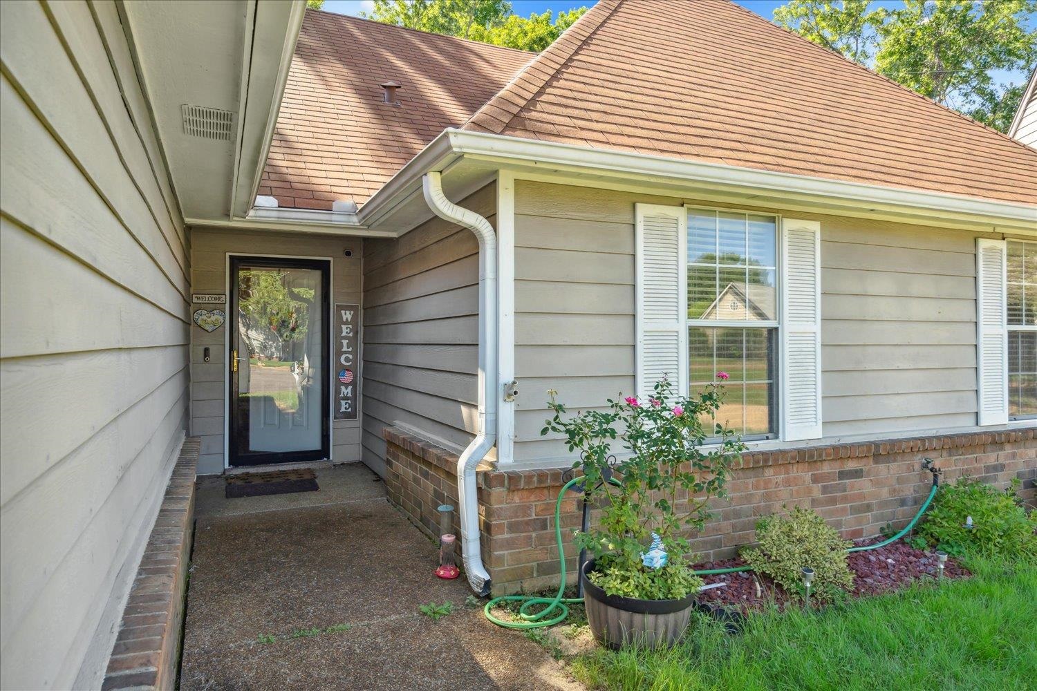 a front view of a house with garden