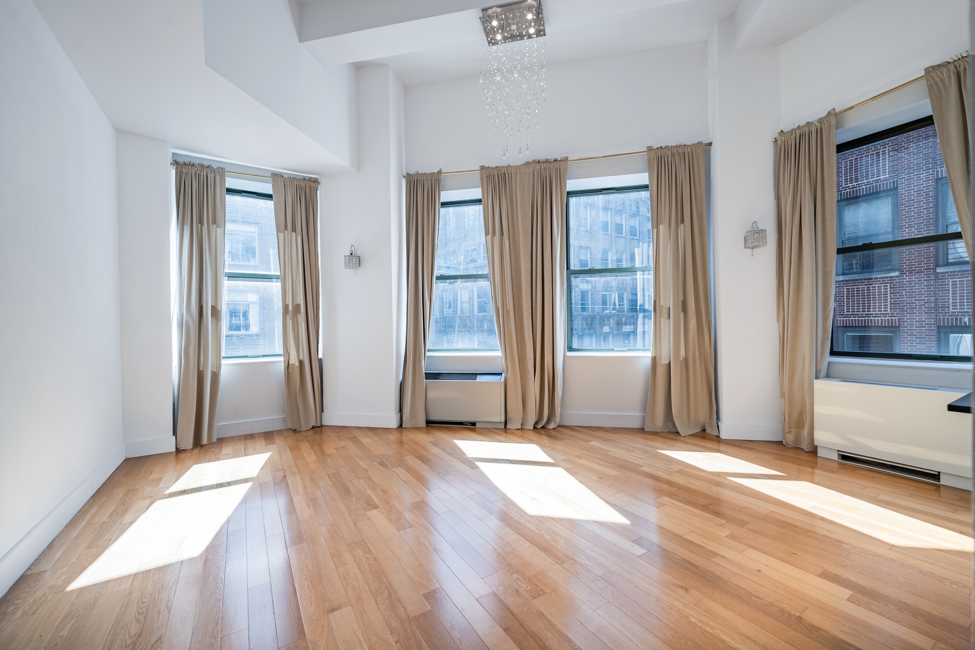 a view of a big room with windows and entryway