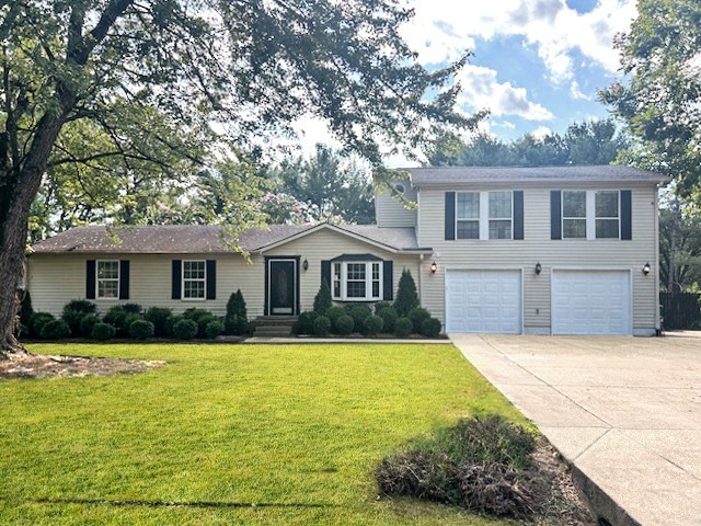 a front view of house with yard and trees