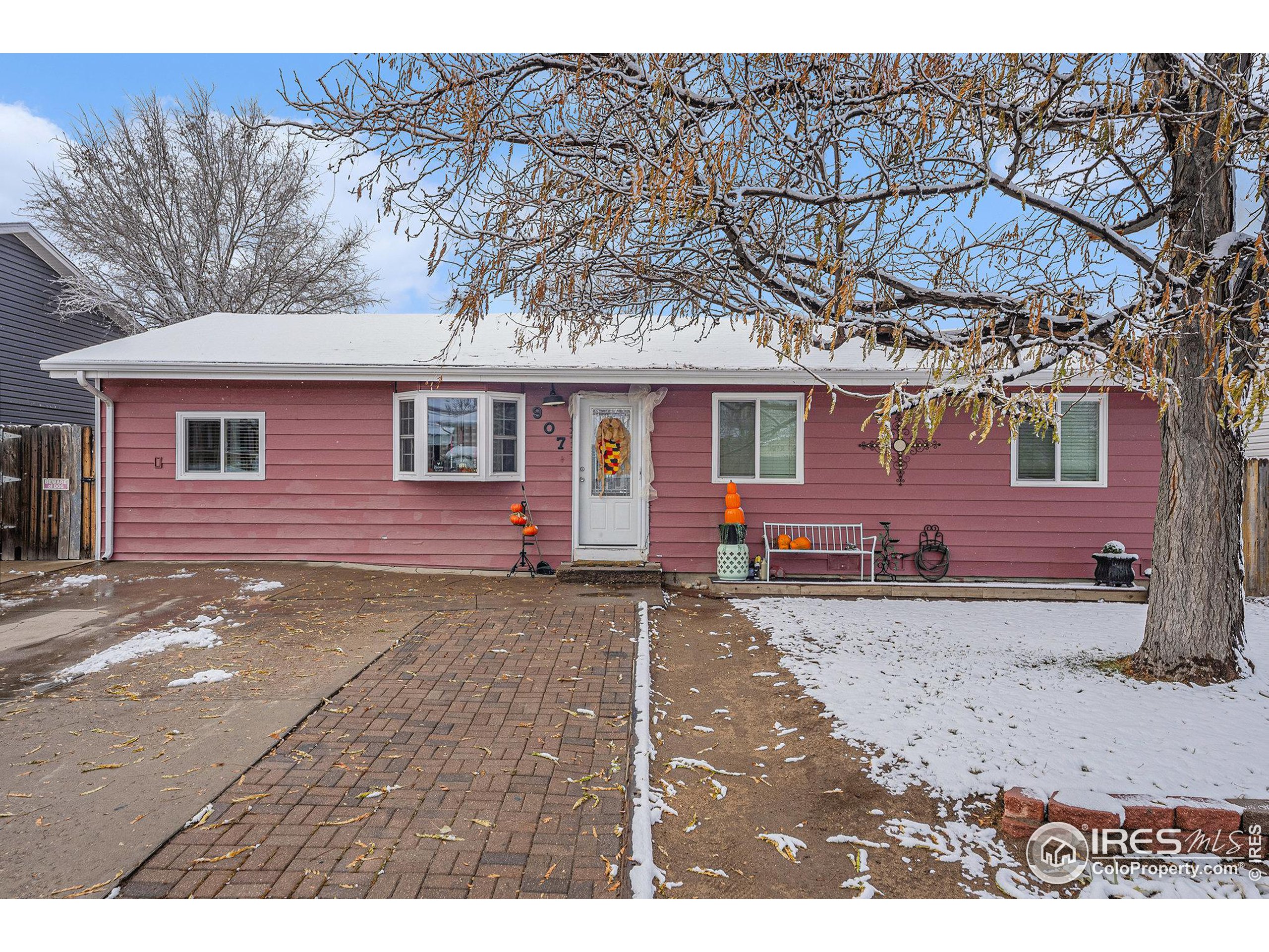 a view of a house with a yard covered in snow