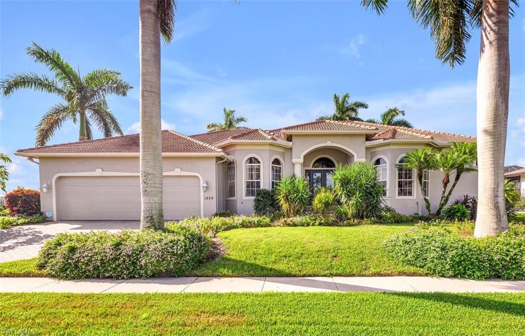 a front view of a house with a garden