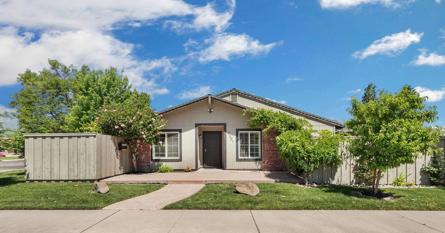 a front view of a house with a yard and a garage