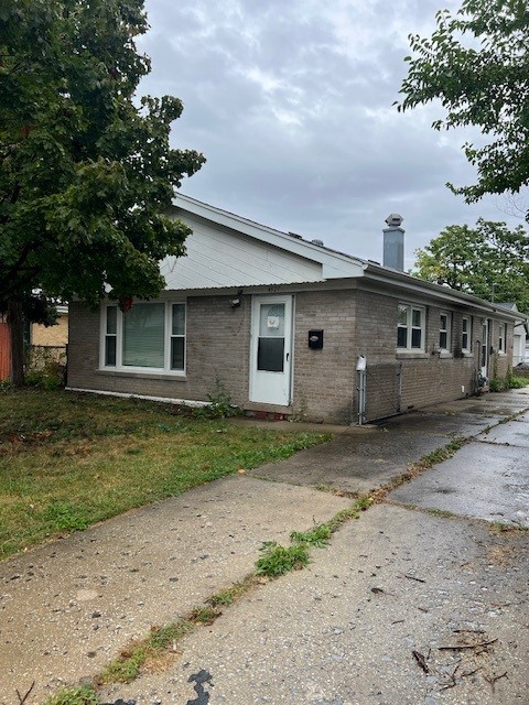 a front view of a house with a garden and yard