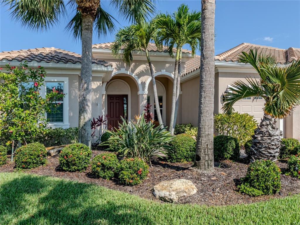 a front view of a house with a garden