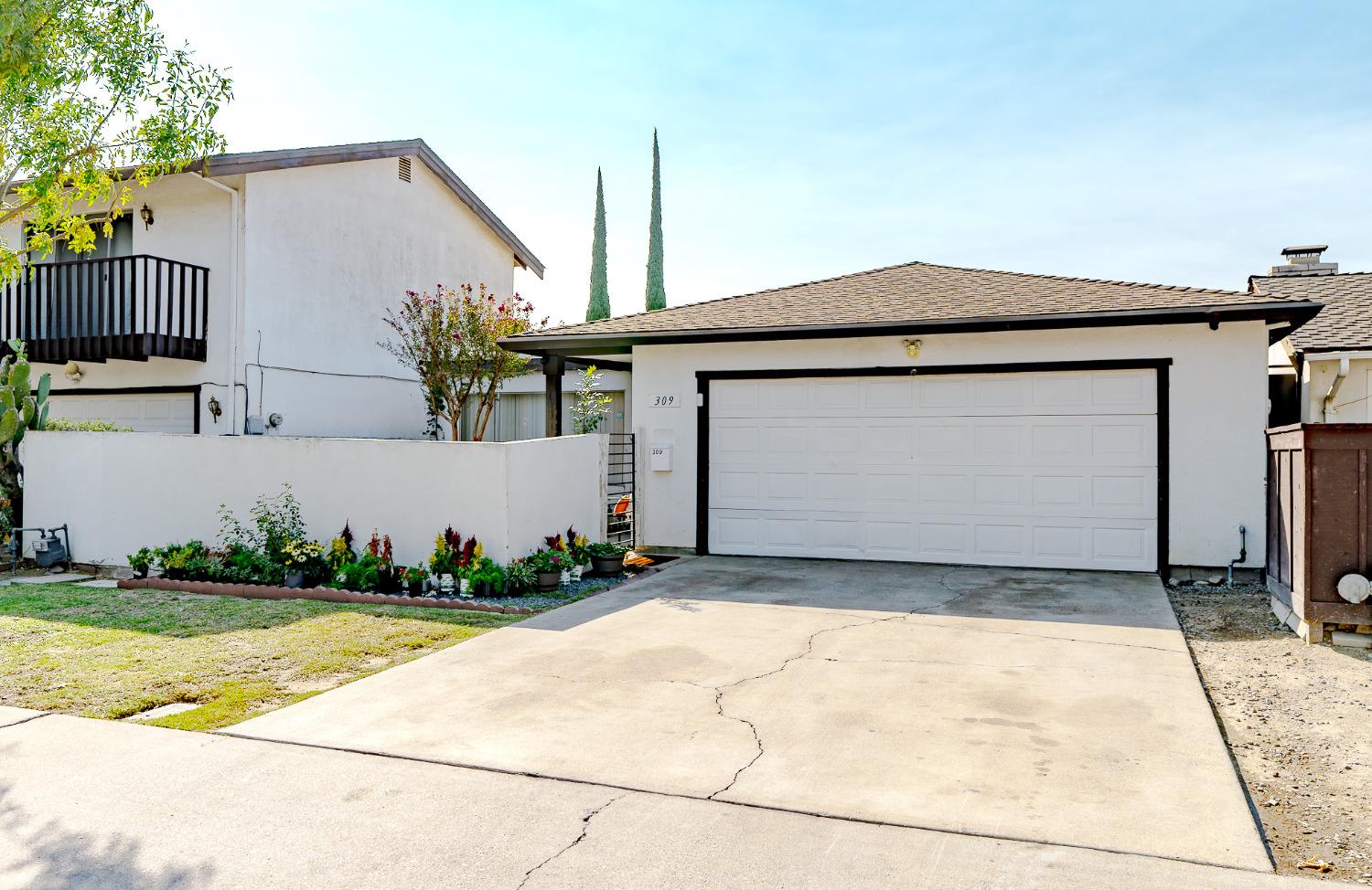 a front view of a house with a garden