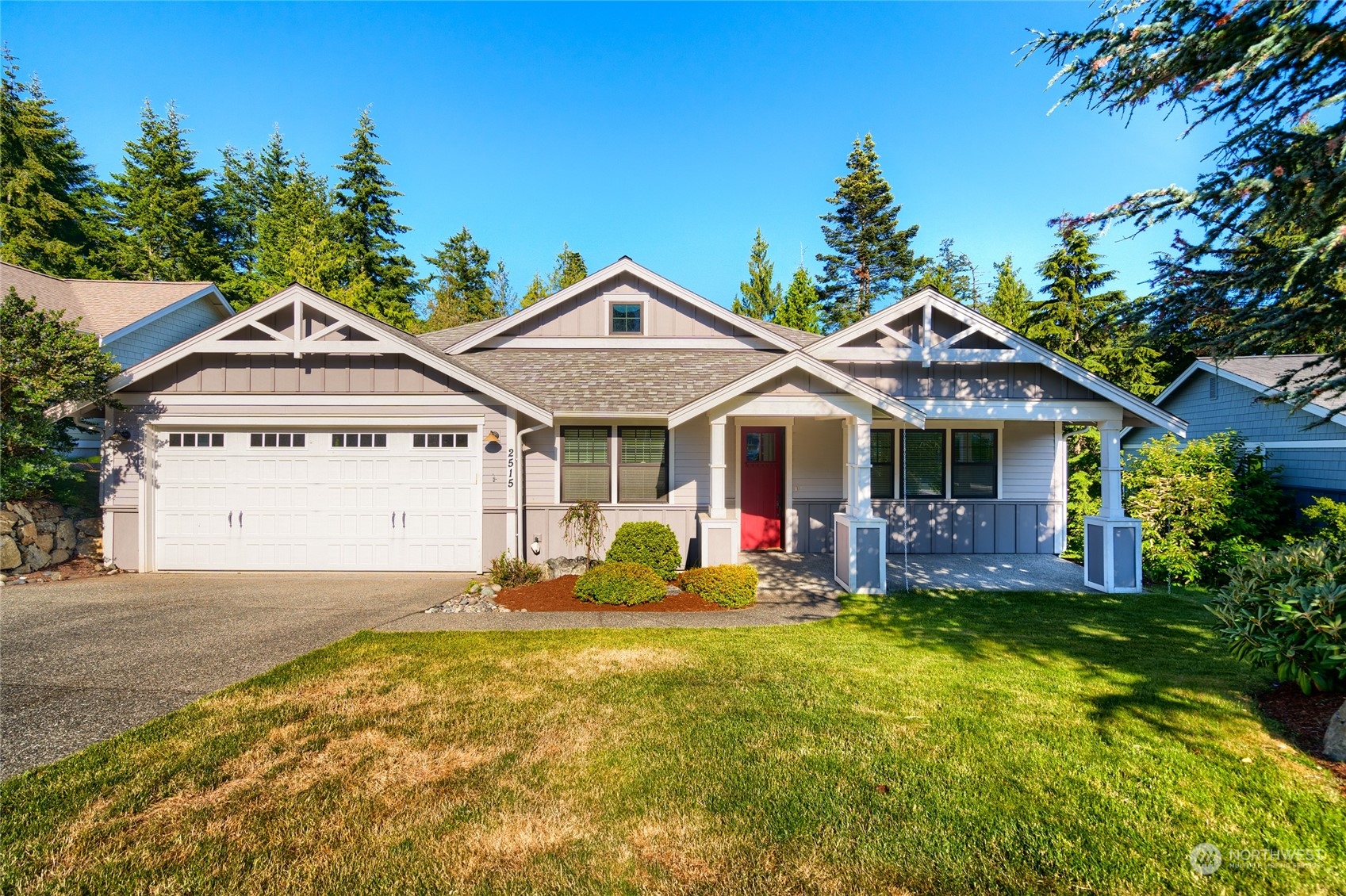 a view of a house with a big yard and large trees