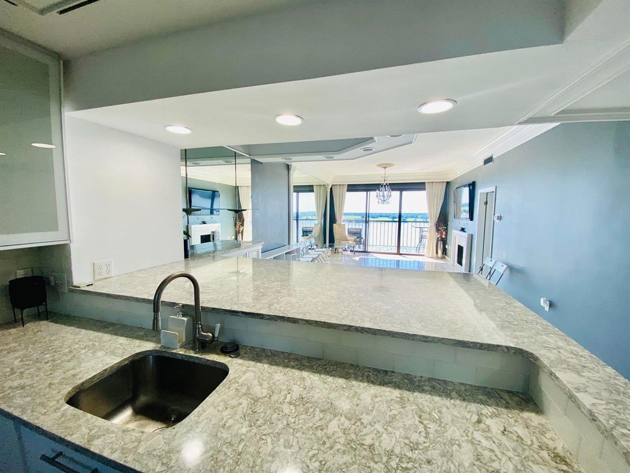 a kitchen with a sink and a stove top oven