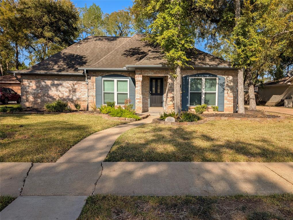 a front view of a house with a garden and patio