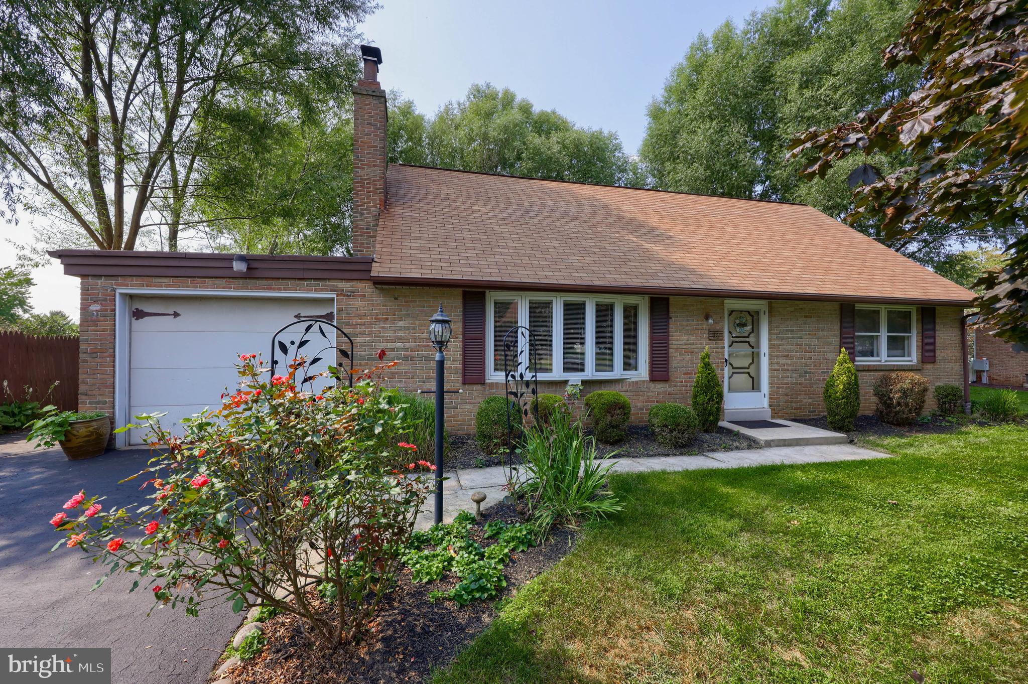 a front view of a house with garden and porch