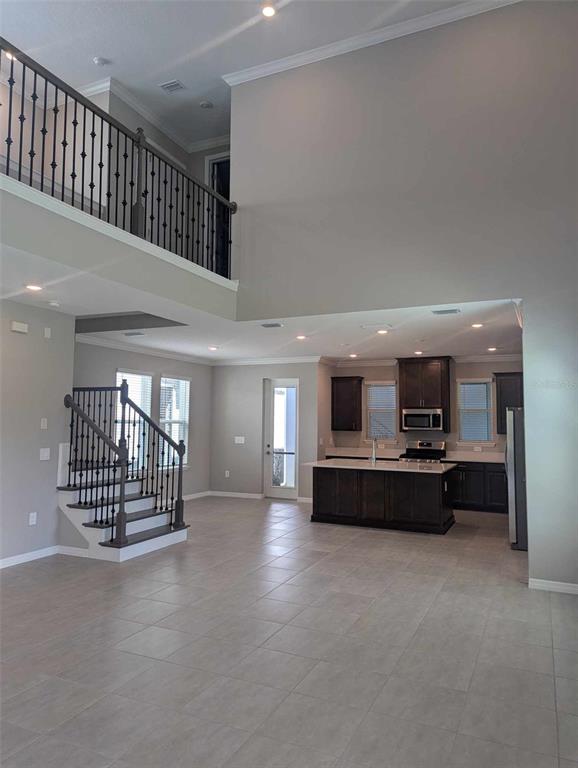 a view of a livingroom with furniture and staircase