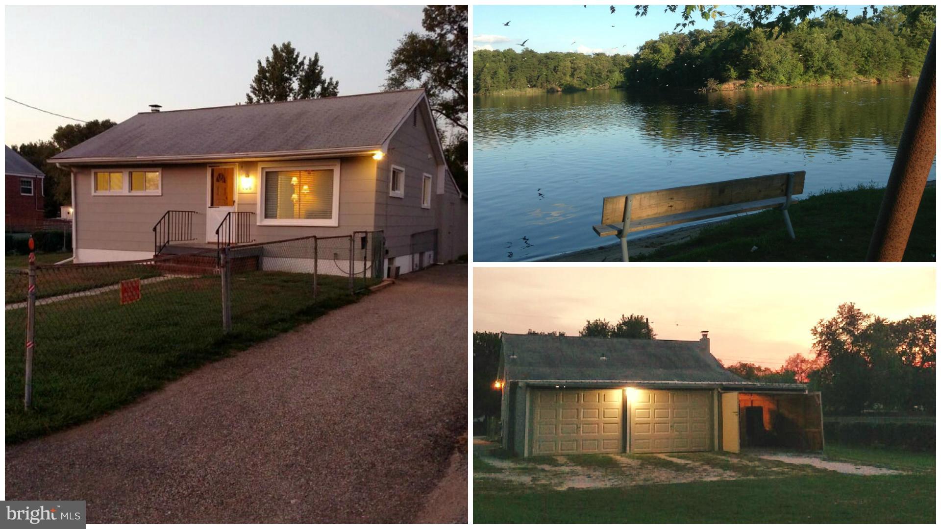 a view of a house with yard and lake view