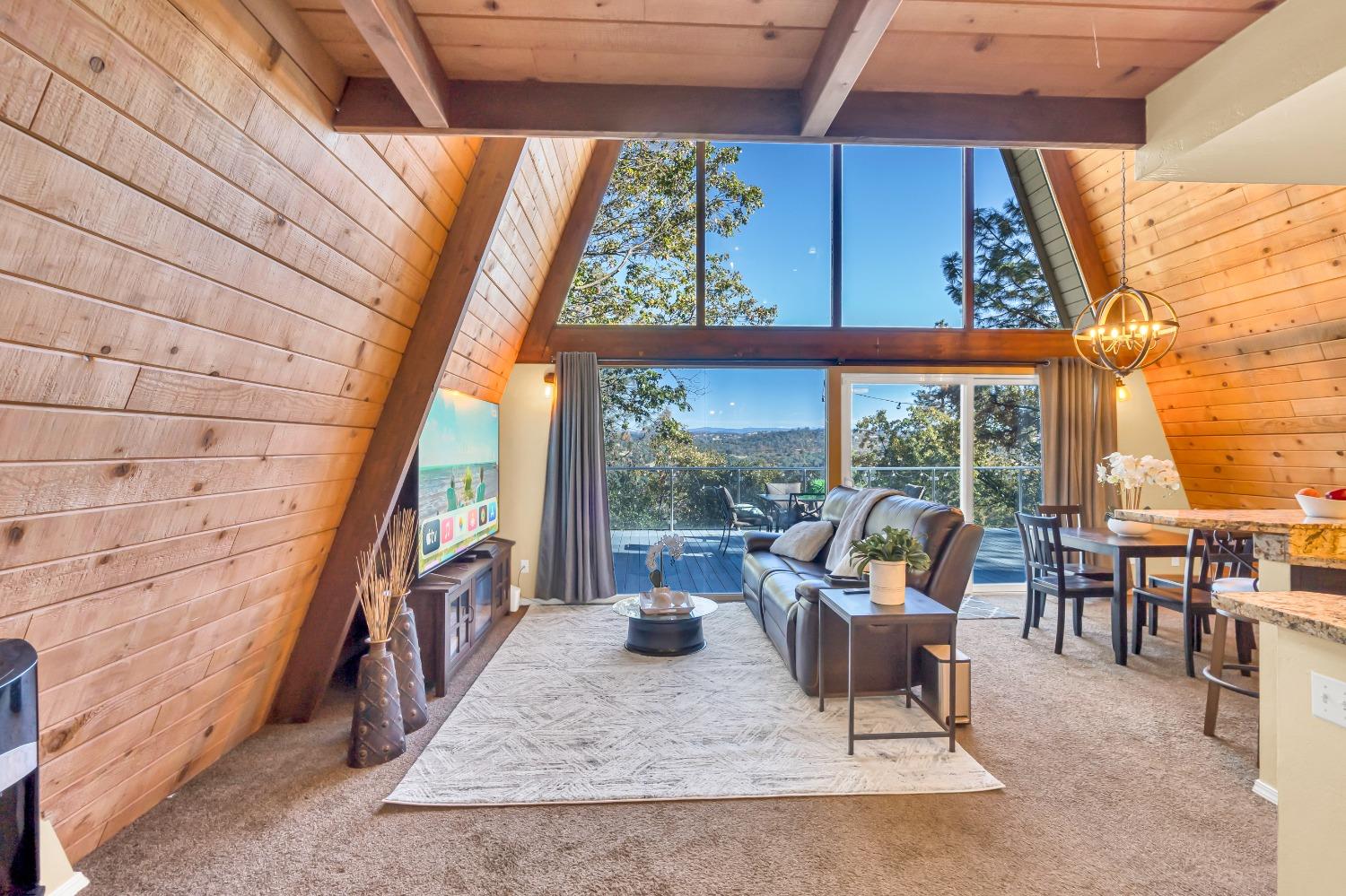 a living room with furniture and a floor to ceiling window