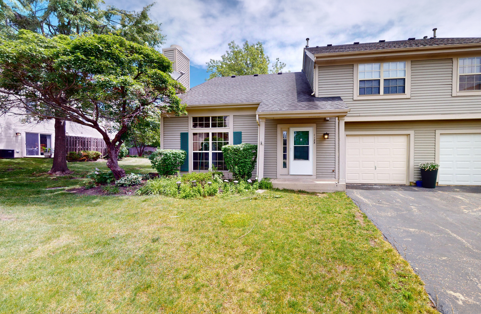 a front view of a house with garden