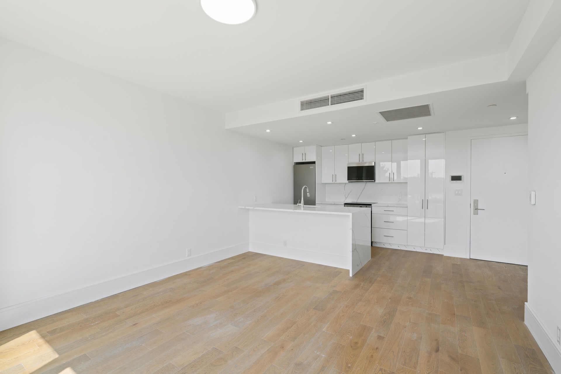 a view of a kitchen with microwave and cabinets