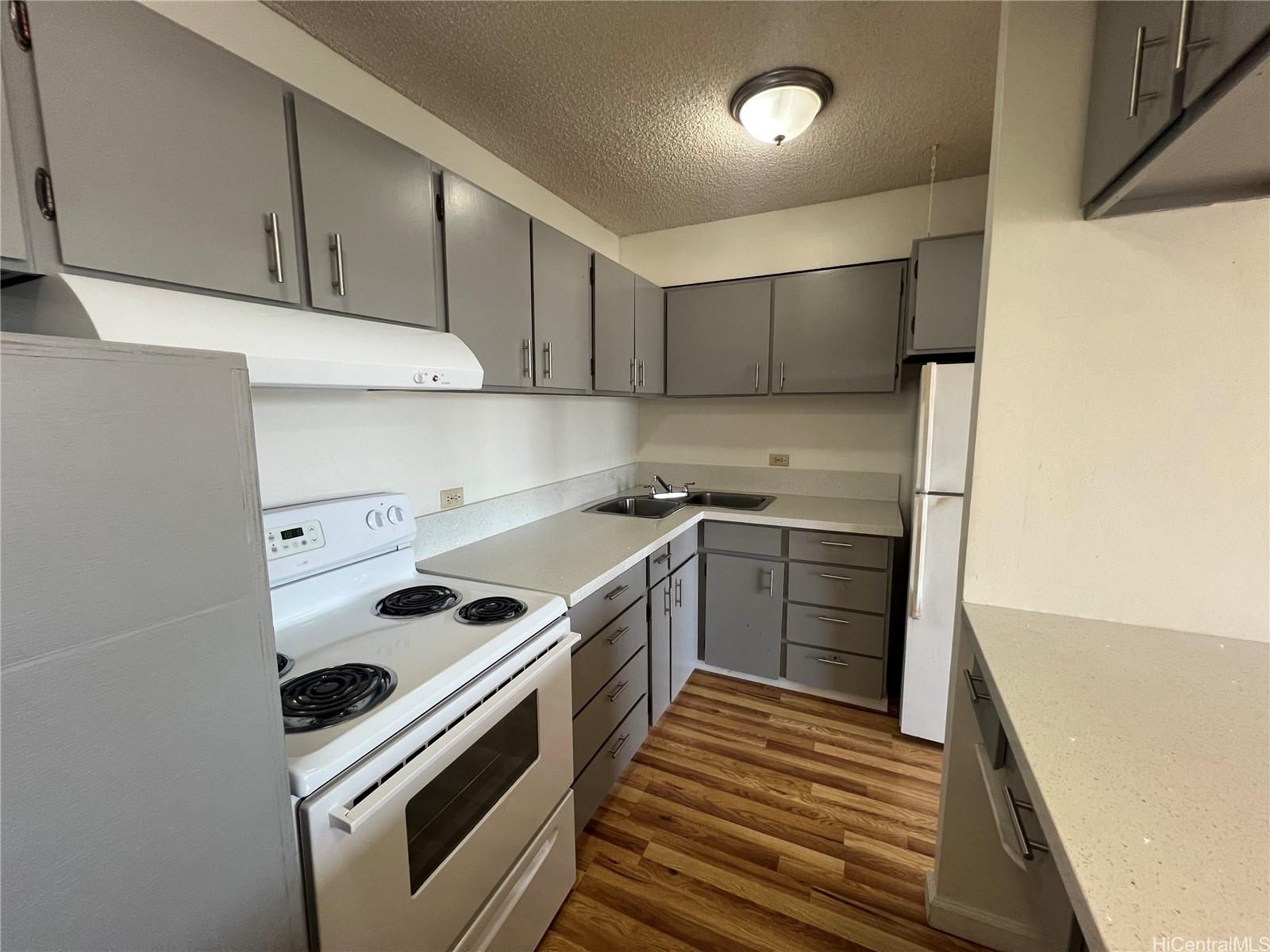 a kitchen with a stove sink and cabinets