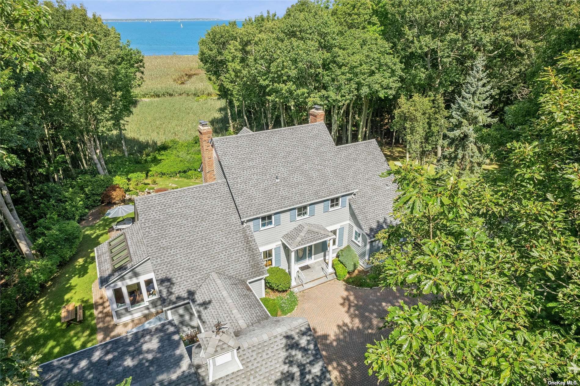 an aerial view of a house with garden space and street view