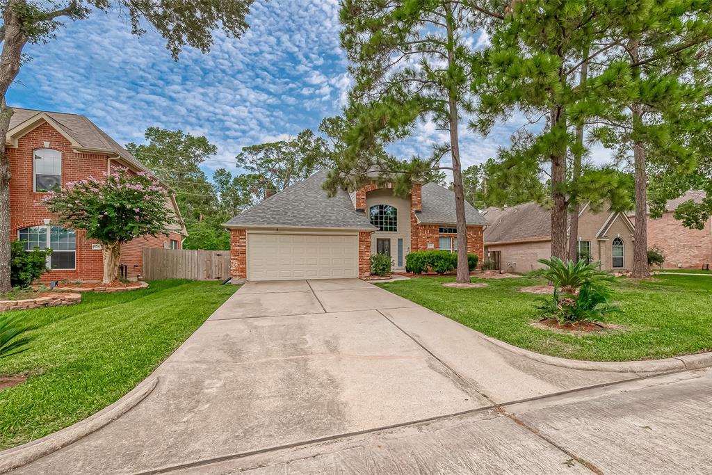 a front view of a house with a yard and a garage