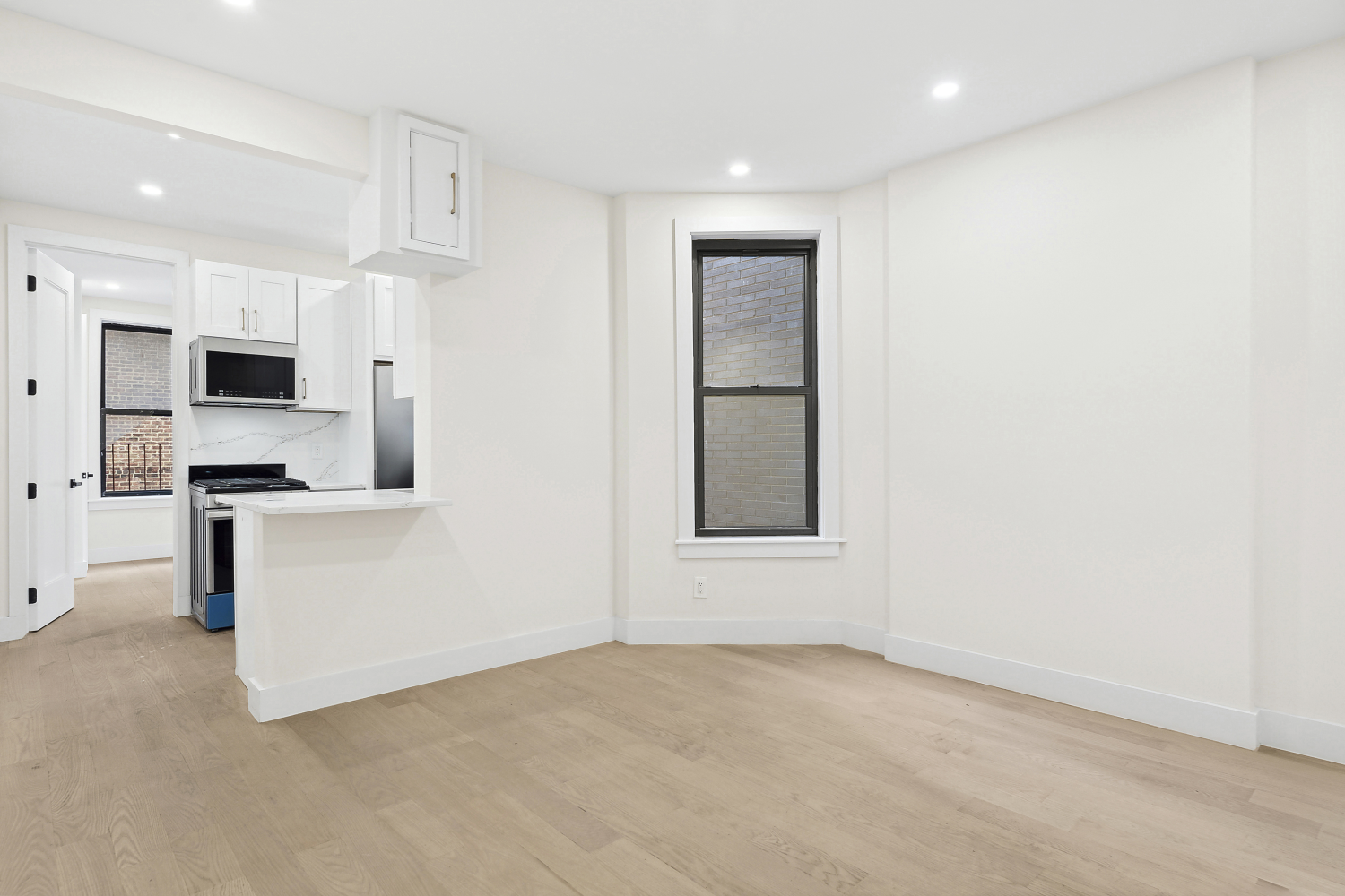 a view of a kitchen with microwave and cabinets